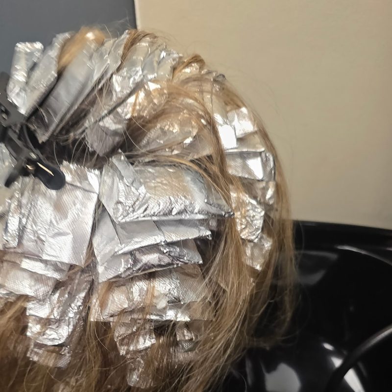 Highlights in progress: foils sectioned through the hair at the shampoo bowl